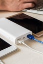 Power bank charges cell phone and tablet on desk