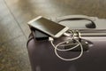 Power bank charges smartphone on the travel bag at the international airport