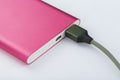 Power bank for charging mobile devices. Pink smart phone charger with power bank. battery bank Royalty Free Stock Photo