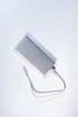 Power bank for charging mobile devices. White smart phone charger with power bank.