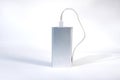 Power bank for charging mobile devices. White smart phone charger with power bank.