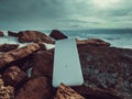 Power bank in hands. Tourist charges a devices in nature, against the backdrop of a winter mountains landscape