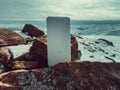 Power bank in hands. Tourist charges a devices in nature, against the backdrop of a winter mountains landscape