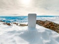 Power bank in hands. Tourist charges a devices in nature, against the backdrop of a winter mountains landscape