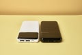 Power banks for charging mobile devices. White and black smart phone charger. External battery for mobile devices