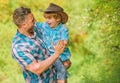 Power being father. Rustic family. Growing cute cowboy. Small helper in garden. Little boy and father in nature Royalty Free Stock Photo