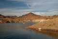 Power Boat on desert lake with rocky hills and blue sky and clouds at Lake Mead Nevada Royalty Free Stock Photo