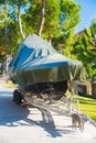 power boat parked covered white protective plastic film New boats in cover casing shrink wrap on sailboat stored for winter