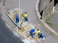 Power cable laying, group of builders, urban street, top view