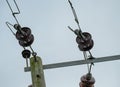 High voltage electrical power cables and insulators seen on wooden poles. Royalty Free Stock Photo