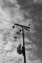 High voltage electrical power cables and transformer seen erected on a wooden pole. Royalty Free Stock Photo