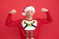 The power of Christmas. Christmas elf show his strength. Santa Claus man smile flexing arms. Happy new year Royalty Free Stock Photo