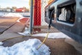 Power cord plugged into a vehicle engine heating block on a bus in a cold climate