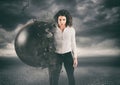 Power and determination of a young business woman against a wrecking ball
