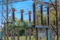 Power distribution - cables, ceramic insulators, fuses, transformer, etc. against the blue sky. Royalty Free Stock Photo