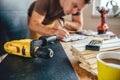 Power drill and Man making draft plan in the background Royalty Free Stock Photo
