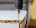 power drill penetrating a wooden surface, emphasizing the tool and material in a home improvement or DIY context. Royalty Free Stock Photo