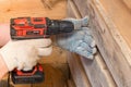 A carpenter works with a manual power tool, close-up