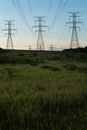 Power Electrical Lines From Hydro Electric Plant by Fields at Sunrise Sunset Royalty Free Stock Photo