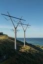 Power Electrical Lines From Hydro Electric Plant on Hill Meeting Water Royalty Free Stock Photo