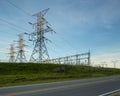 Power Electrical Lines From Hydro Electric Plant by Road and Fields Royalty Free Stock Photo