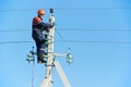 Power electrician lineman at work on pole Royalty Free Stock Photo