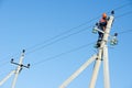 Power electrician lineman at work on pole