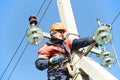 Power electrician lineman at work on pole Royalty Free Stock Photo