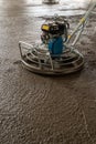 Power float grinder machine on wet concrete background closeup shot with selective focus and blur Royalty Free Stock Photo