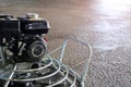 Power float grinder machine on wet concrete background closeup shot with selective focus and blur. Royalty Free Stock Photo