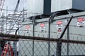 Power grid substation with high voltage warning signs behind a barbed wire fence. Royalty Free Stock Photo