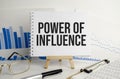 power of influence, text on white paper on the light background with charts paper