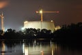 Power lights illuminated at night. Chimneys launching smoke. Cranes, extending the electron. Heat generation. Royalty Free Stock Photo