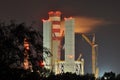Power lights illuminated at night. Chimneys launching smoke. Royalty Free Stock Photo