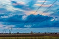 Power line in cultivated fields Royalty Free Stock Photo