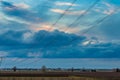 Power line in cultivated fields Royalty Free Stock Photo