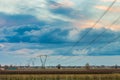 Power line in cultivated fields Royalty Free Stock Photo