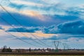 Power line in cultivated fields Royalty Free Stock Photo