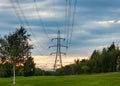 Power line and electrical transmission tower or electricity pylon or power tower on field Royalty Free Stock Photo