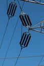 Power line insulators on a blue sky Royalty Free Stock Photo