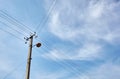 Power line post with electricity cables against a clear blue sky Royalty Free Stock Photo