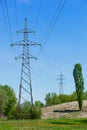 Power line pylons surrounded with greenery and trees Royalty Free Stock Photo