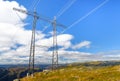 Power line structure installed over mountains with blue sky Royalty Free Stock Photo
