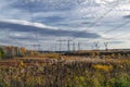 Power line support against the autumn landscape. Electricity transmission air-line support. Shining autumn sunny day. Royalty Free Stock Photo