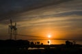 Power line support against the background of a red sunset on the Royalty Free Stock Photo