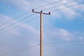 Power line support pole concrete with high voltage wires and ceramic Insulators Royalty Free Stock Photo