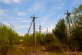 Power line support. Rustic wooden Telegraph pole full length against a blue sky with clouds. Electric pole with wires in Royalty Free Stock Photo