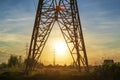 Power line support tower and sunset sun Royalty Free Stock Photo