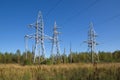 Power line supports near the forest Royalty Free Stock Photo