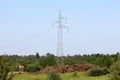 Power line utility pole with wires connected with transparent glass insulators next to hunting observation tower and cut down logs Royalty Free Stock Photo